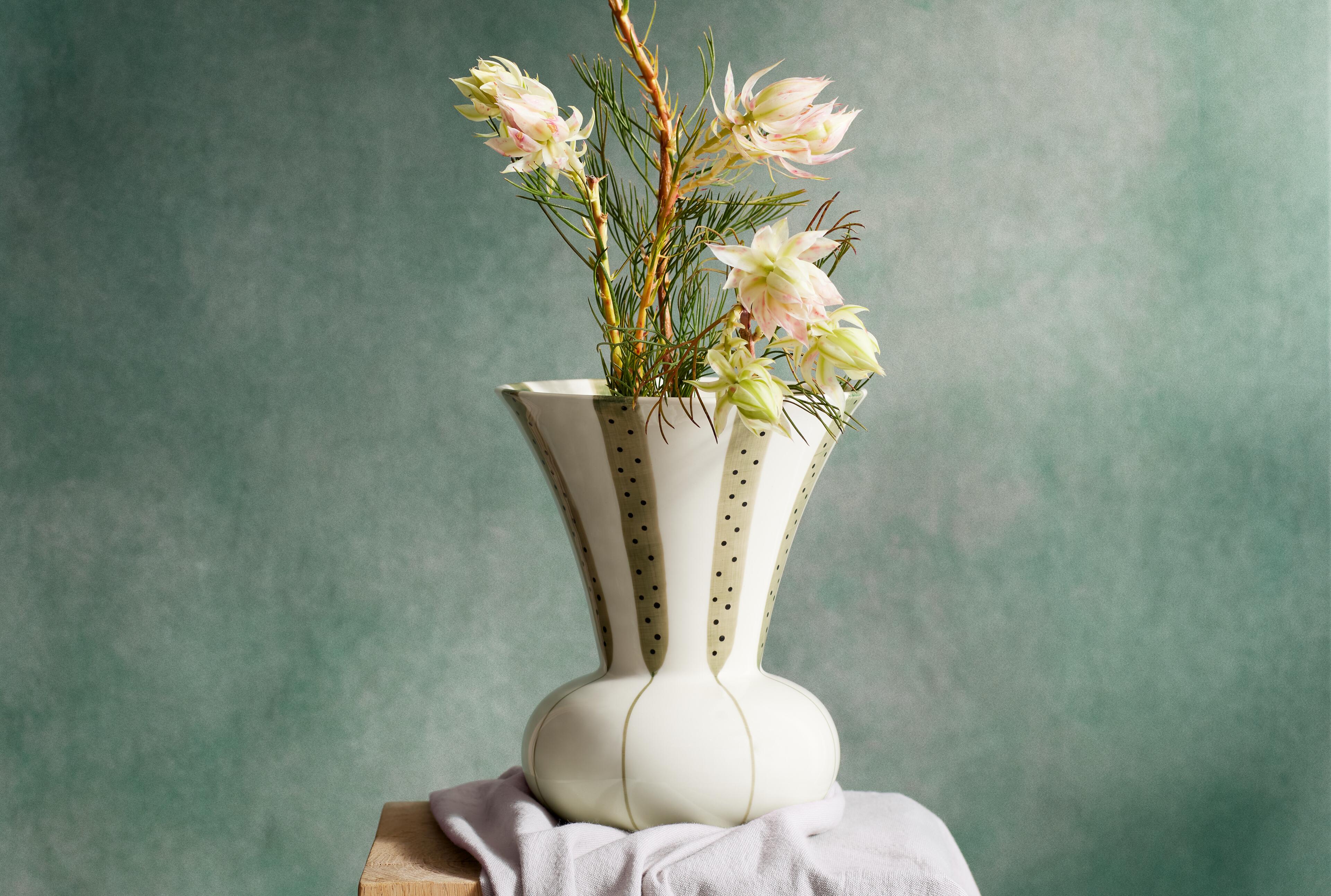 Vases and flower pot covers from Rosendahl.com. MeyerLavigne Kähler patterned vase with holes in the top and flowers.