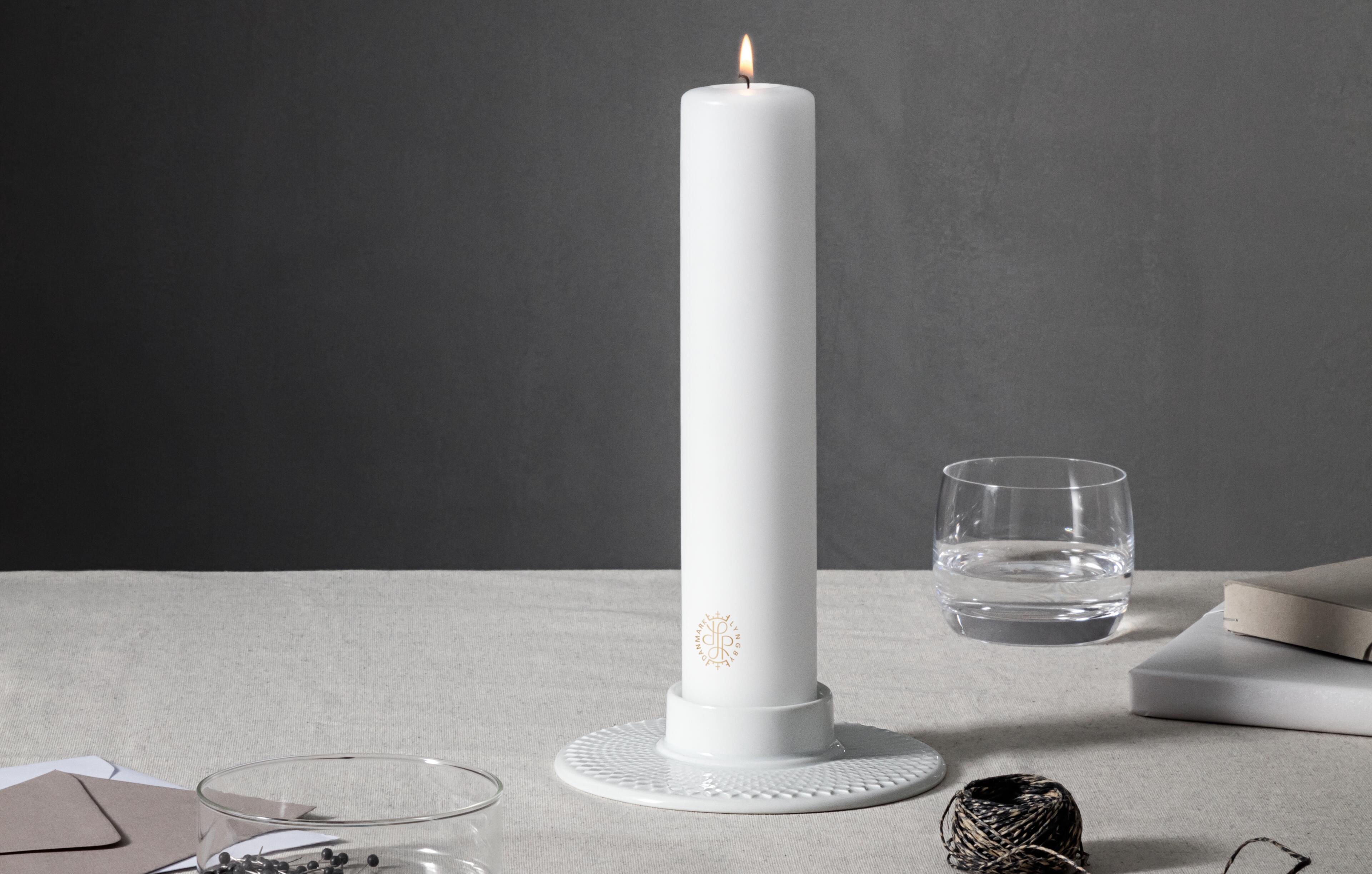 White candle with white porcelain pillar candleholders from Lyngby Porcelæn.