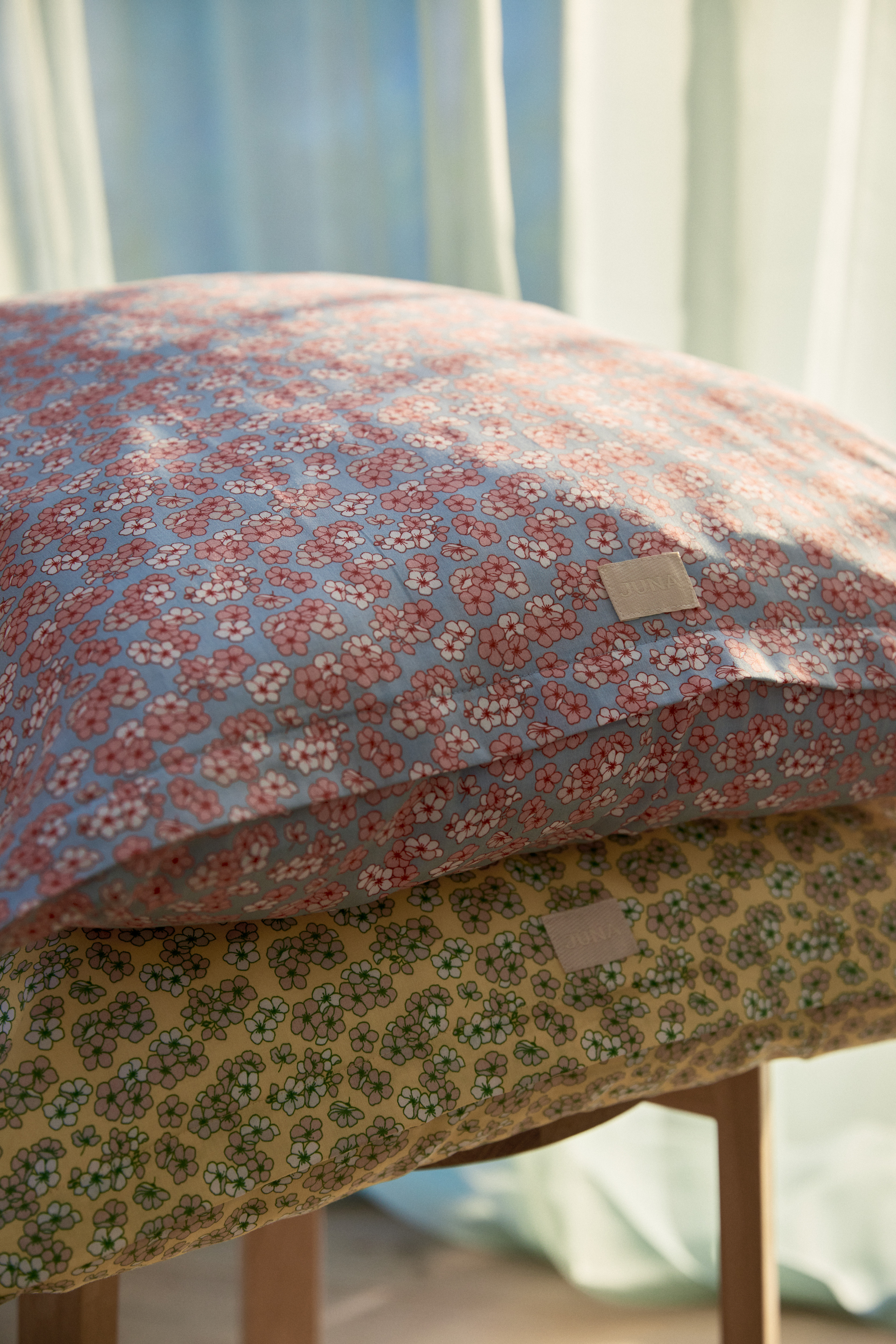 Cushions with floral cushion cover from JUNA on chair