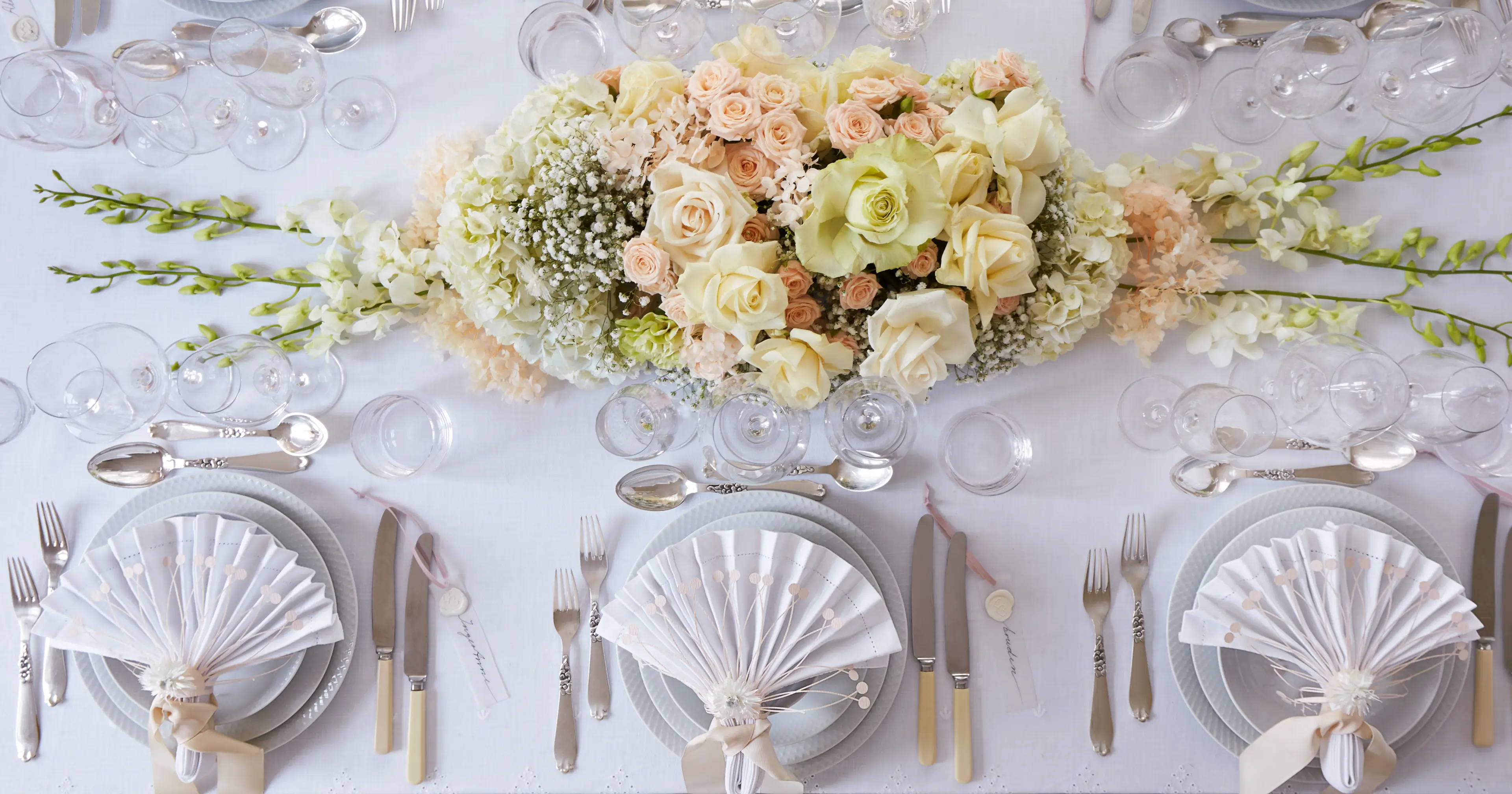 Table setting with beautiful plates and flowers