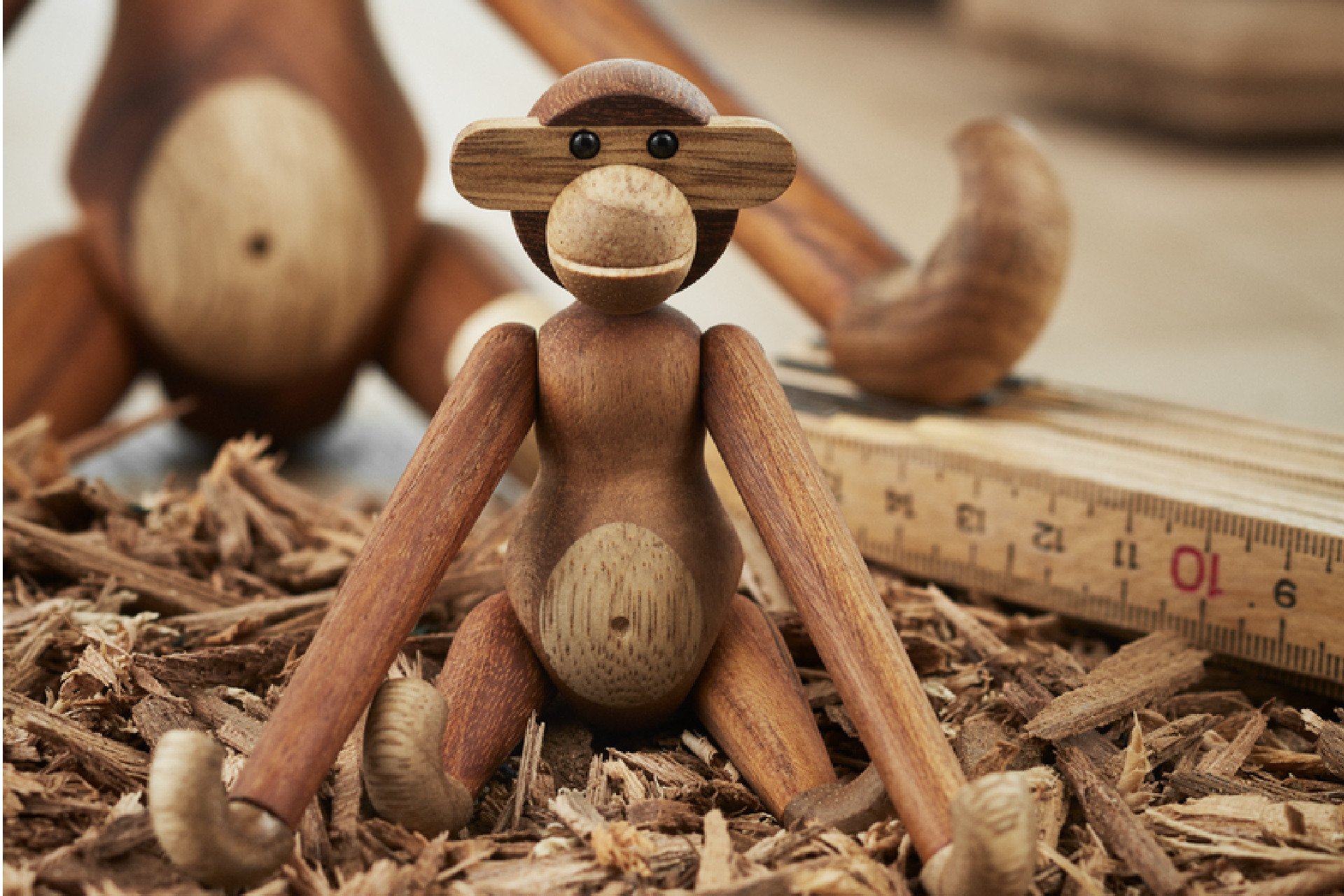 Monkey from Kay Bojesen sitting among wood shavings and ruler