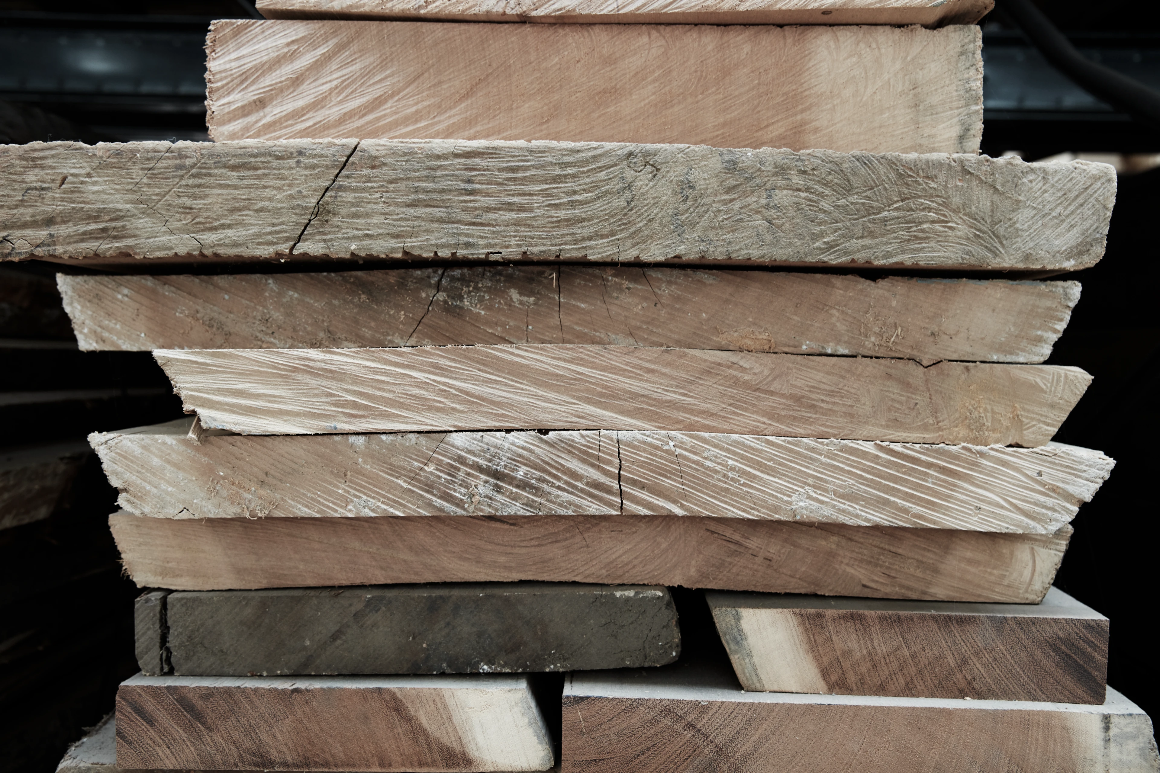 Close-up of wooden planks showing detailed wood grain and natural patterns of the tree’s growth rings