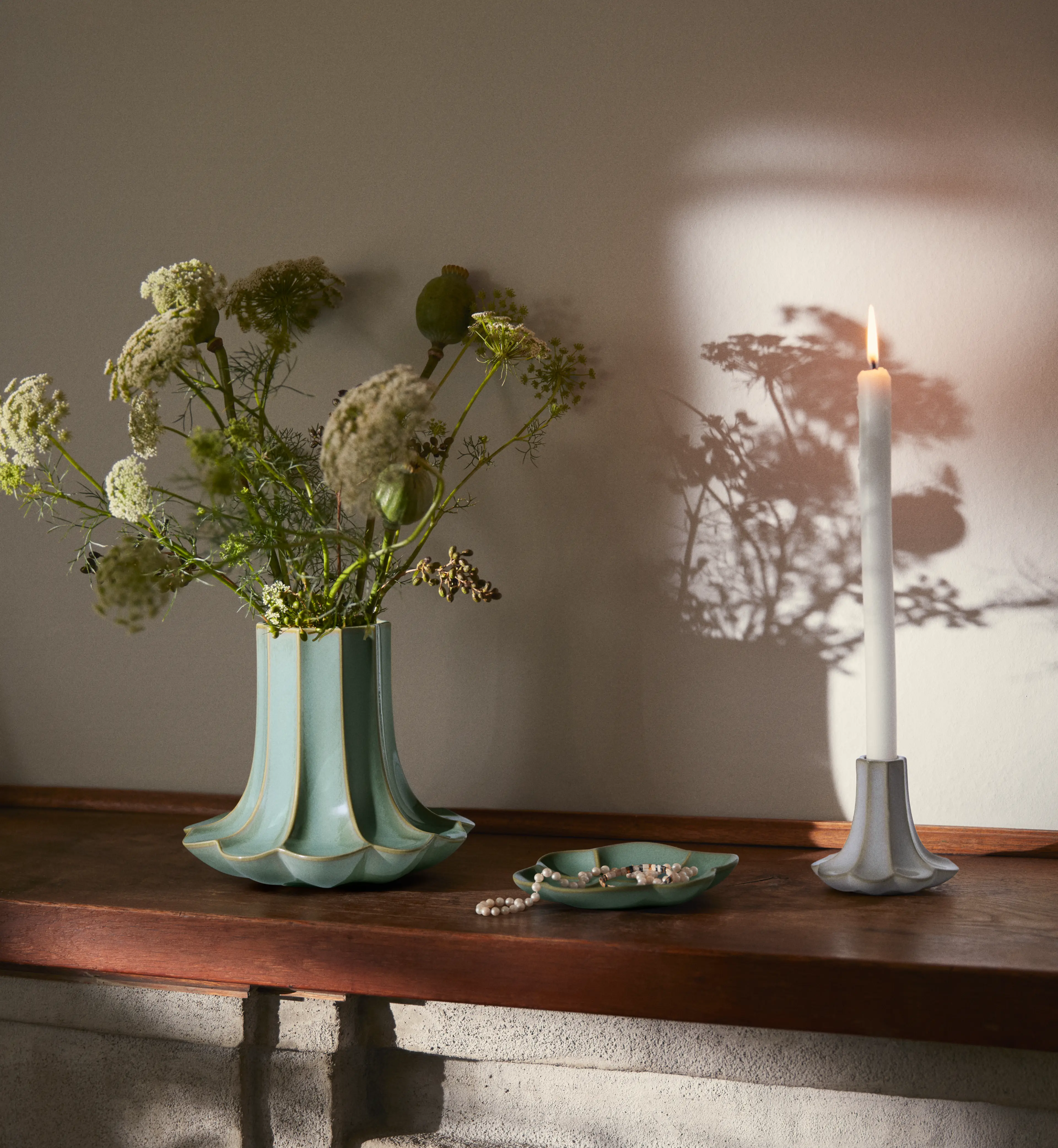 Kähler Kantarel ceramic vase, candle holder and dish inspired by chanterelle mushroom design on wooden table