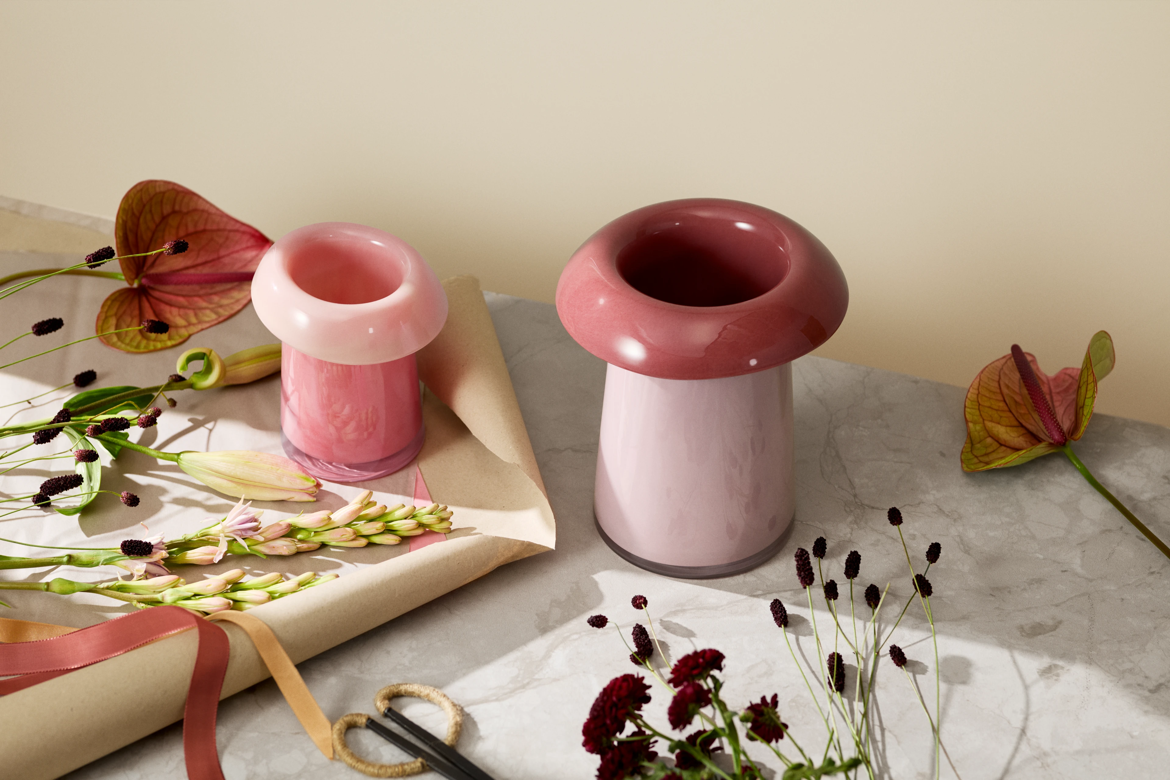 Holmegaard Soma vase in pink and blush with flowers on a black side table in a stylish interior