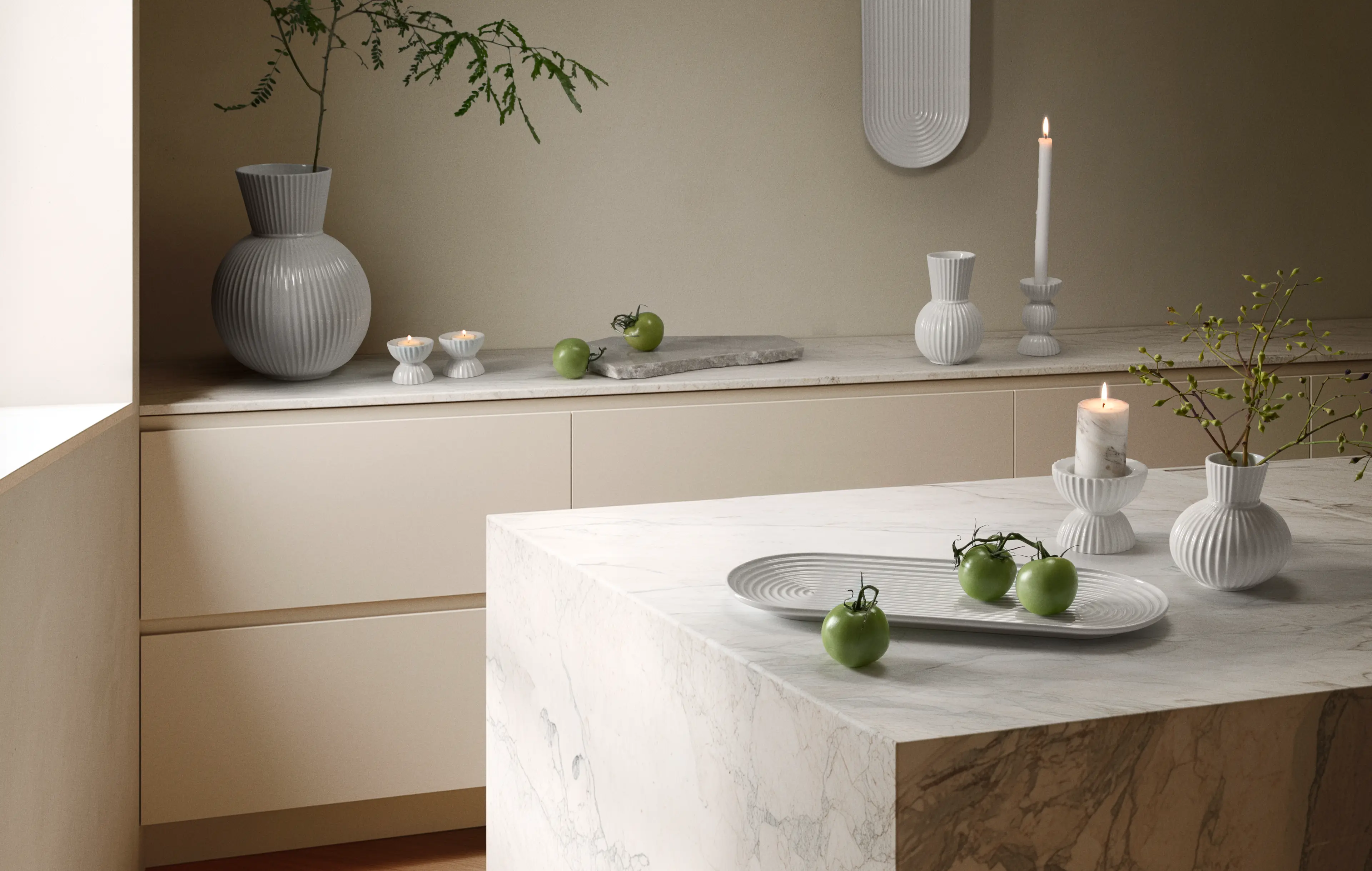 Minimalist kitchen scene with vases, plates and candles from lyngby Porcelæn Lyngby Tura serie in calm tones.